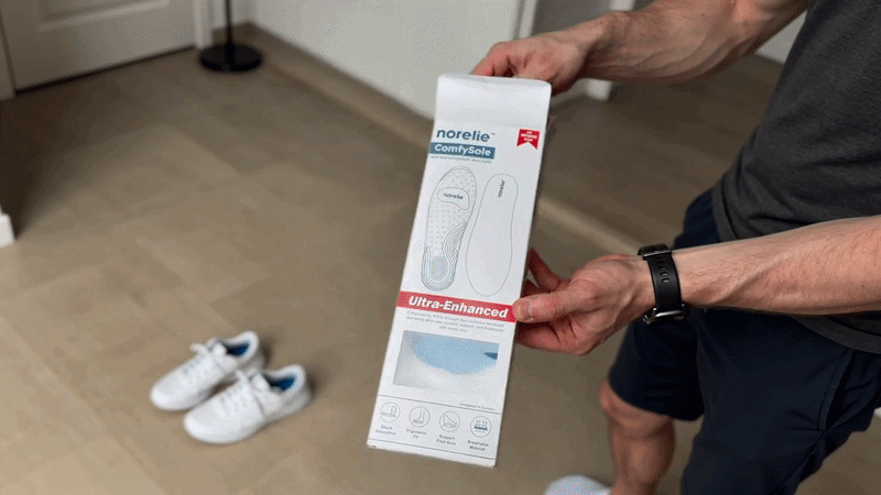 Hands holding the Norelie ComfySole 2.0 retail box